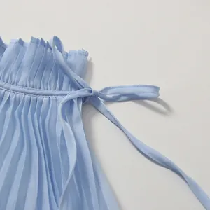 Close-up detail of the ruffled stand-up collar and tie-bow on light blue pleated dress