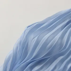 Detailed macro view of light blue accordion pleats on summer resort style dress