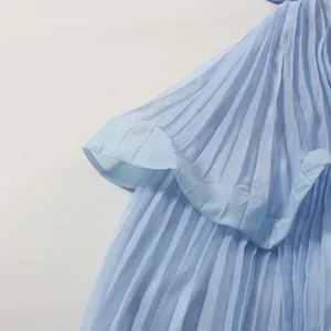 Macro view of light blue pleated fabric texture on a elegant summer resort dress