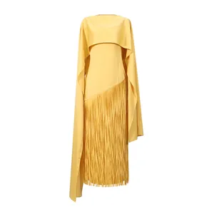 Detail van een gele cape-avondjurk met elegante franjes en een asymmetrische snit