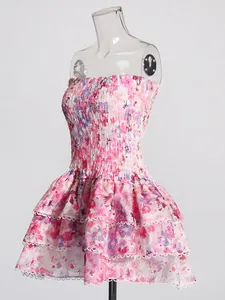 Pink floral smocked strapless dress with tiered ruffled skirt and lace trim detail