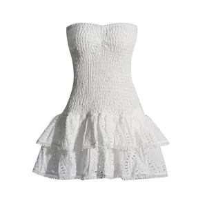 Elegant white strapless smocked dress with eyelet lace details and layered ruffles