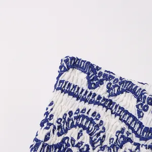 Close-up detail showing the intricate blue and white smocked texture of this bohemian tube dress