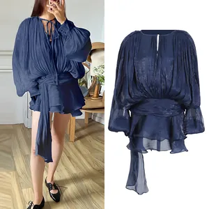 Elegant navy blue pleated long-sleeve mini dress with loose fit and waist tie detail.