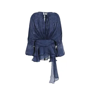 Rear view detail of dark blue long-sleeved dress with ruffled hem and flowing sash