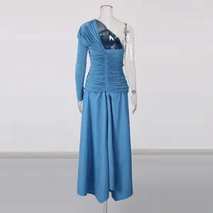 Close-up detail of the deep sea blue one-shoulder ruched dress with asymmetrical hem