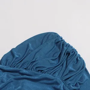 Close-up view of the sophisticated deep sea blue ruched fabric texture for a summer dress