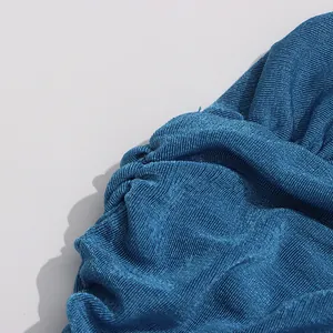 Detailed macro shot of deep sea blue pleated fabric showing fine ribbed textures