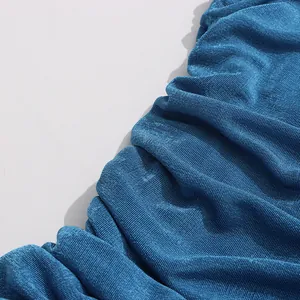 Close-up of deep blue pleated fabric texture showing fine vertical lines and sheen