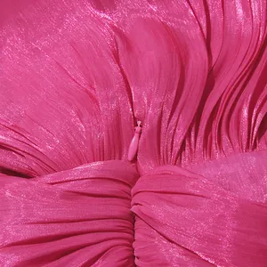 Detailed view of the invisible zipper and shimmering fuchsia pleated dress fabric texture
