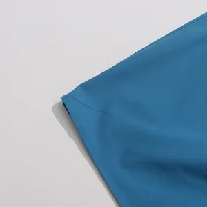 Detailed view of the fine stitching on the hem of a deep sea blue summer maxi dress