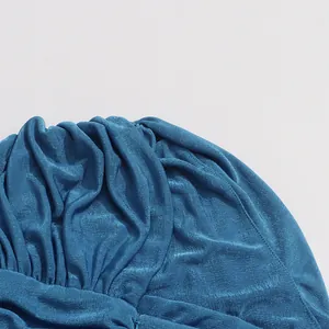 Macro shot of deep sea blue pleated fabric texture for a stylish summer woman dress.