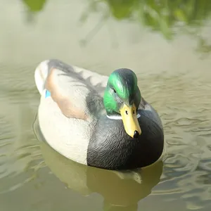 Realistic mallard duck decoy floating on water for hunting or garden decoration.