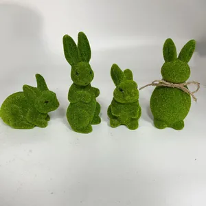 Set of four green flocked bunny figurines in various poses for Easter decor.