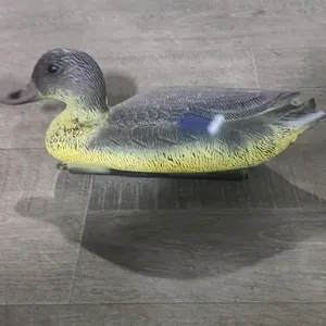 Detailed side view of a realistic plastic duck decoy for garden pond decoration