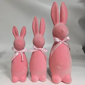 Decorative set of three pink flocked Easter bunny figurines with elegant satin ribbons