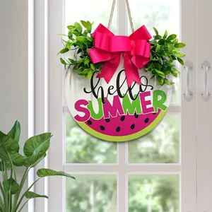 Watermelon welcome sign hung on a white windowed door with a vibrant pink bow detail
