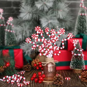 Red and white beaded Christmas candy sprigs displayed in a festive holiday scene