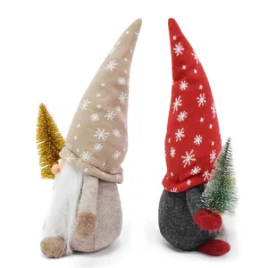 Set of two plush Christmas gnome dolls holding miniature trees for festive decor.
