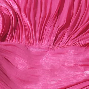 Macro shot showing the detailed texture of bright pink pleated fabric for summer dress