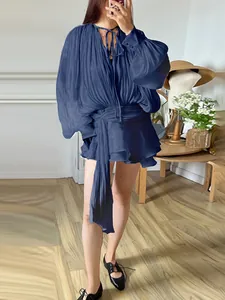 Loose navy blue long-sleeve pleated mini dress with tie-waist ribbon detail