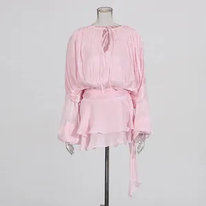 Pink long-sleeve loose pleated mini dress with tie ribbon detail and layered hemline