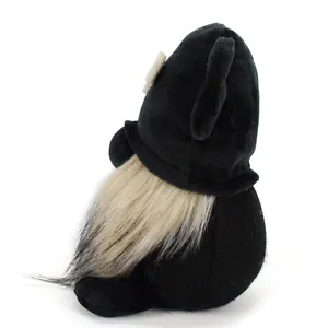Side view of a cute black plush dog gnome doll with long white beard and bone accent.
