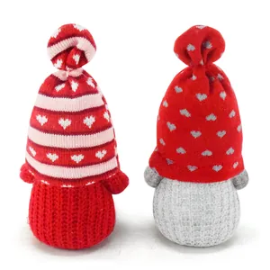 Close-up detail of Valentine's Day faceless gnome plush dolls with heart patterns