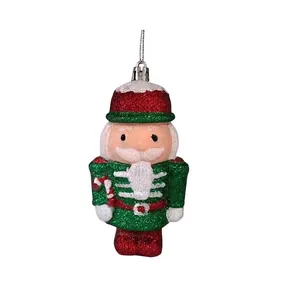 Glittery red and green nutcracker Christmas tree ornament for holiday party decor