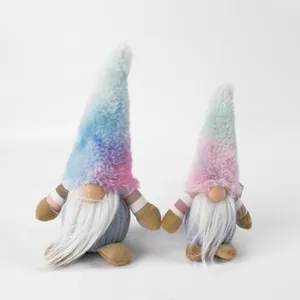 Detail view of two plush gnomes with rainbow hats and long beards on white background