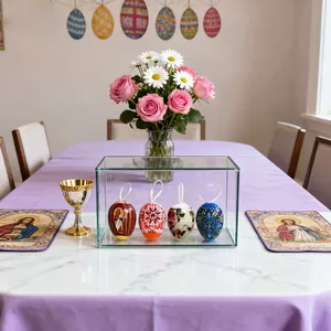Set of four Easter decorative eggs with religious and floral patterns in a display case