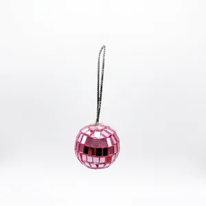 Close-up detail of a pink reflective mirror disco ball with a silver hanging string for party