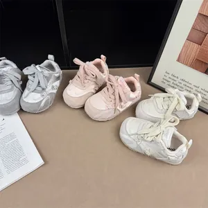 Detailed view of girls' stylish sneakers featuring decorative bowknots in three colors.