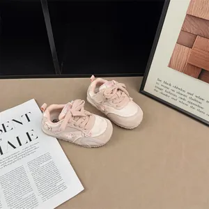 Cute pink girl's sneakers with pearl bow details and velcro straps for spring fashion