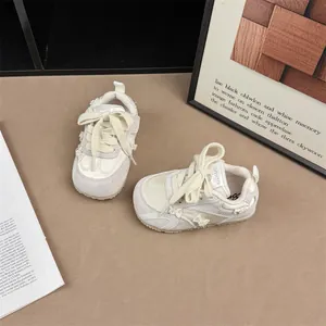 Detailed top-down view of cream girls sneakers featuring stylish bow and pearl accents