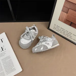 Silver and grey girls' sneakers with small pearl bow details