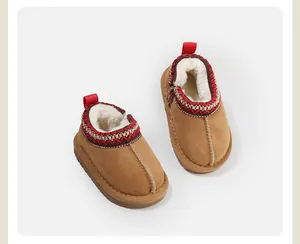 Detail of cozy baby snow boots featuring warm shearling lining and red ethnic trim