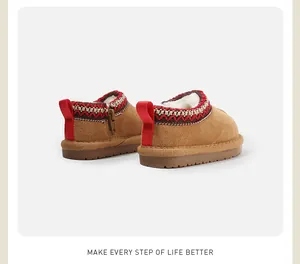 Warm children's suede snow boots with cozy fleece lining and red ethnic trim details.
