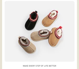Macro view of warm toddler snow boots with thick plush lining and embroidered collar decoration.