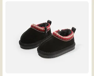 Close-up detail of black baby snow boots with warm fleece lining and embroidered collar