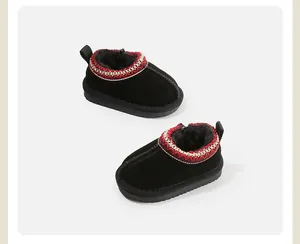 Detailed view of warm black toddler snow boots featuring festive red embroidery and fleece lining