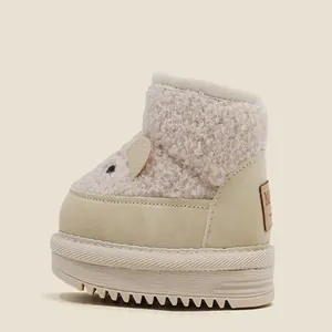 Side detail of a plush cream toddler snow boot with cute cartoon bear ears and thick sole