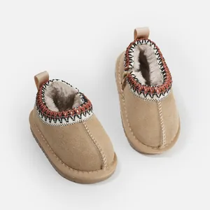 Cozy tan toddler snow boots with warm faux fur lining and ethnic patterned collar.