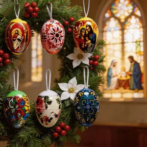 Religious and floral Easter egg ornaments hanging on a decorative evergreen wreath