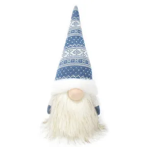 Close-up of plush Christmas gnome with blue knitted hat and white faux fur beard