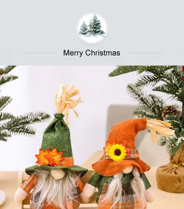 Detailed view of festive autumn gnome doll couple featuring harvest leaves and sunflower