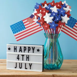 Detailed shot of patriotic glitter star picks in a vase with a 4th of July lightbox