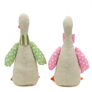 Vue arrière de deux ornements d'oie en tissu faits à la main avec des ailes colorées