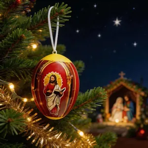 Close-up of religious Jesus icon Easter egg ornament hanging on a festive Christmas tree