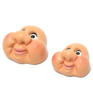Detail view of flesh-colored resin gnome face accessories with large nose and eyes